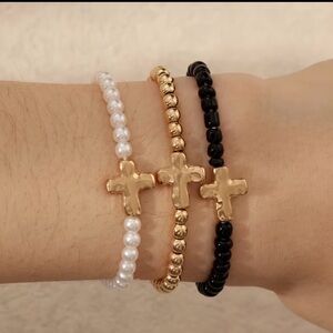 Elegant Gold, Black, and White Cross Bracelets